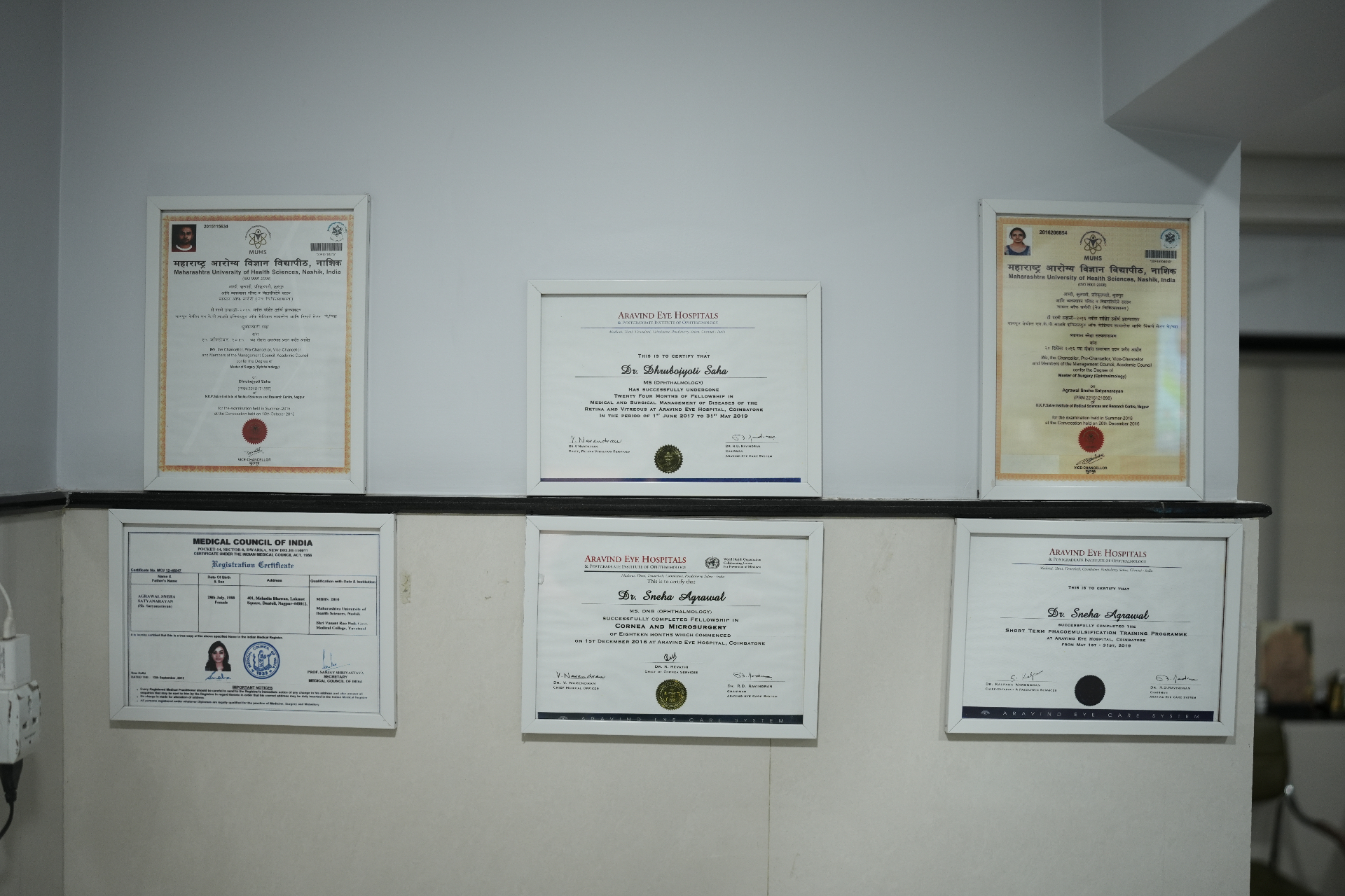 Framed degrees and fellowship certificates of Dr. Dhrubojyoti Saha, Dr. Sneha Agrawal and Dr. Gunjan Rathi Kelkar displayed at Total Retina Eye Care, Nagpur